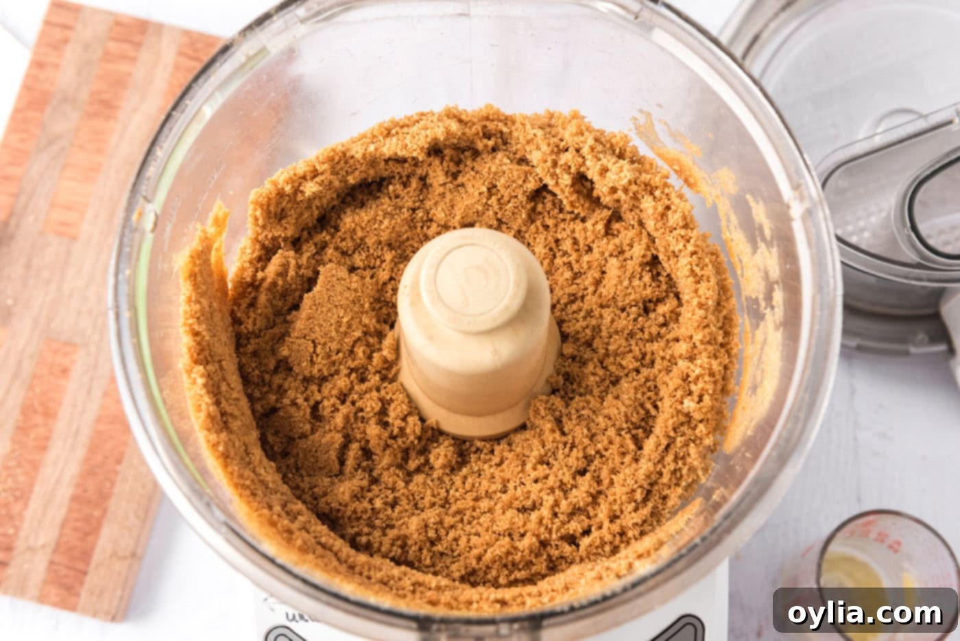 Graham cracker crumbs in a food processor, finely crushed for the cheesecake crust