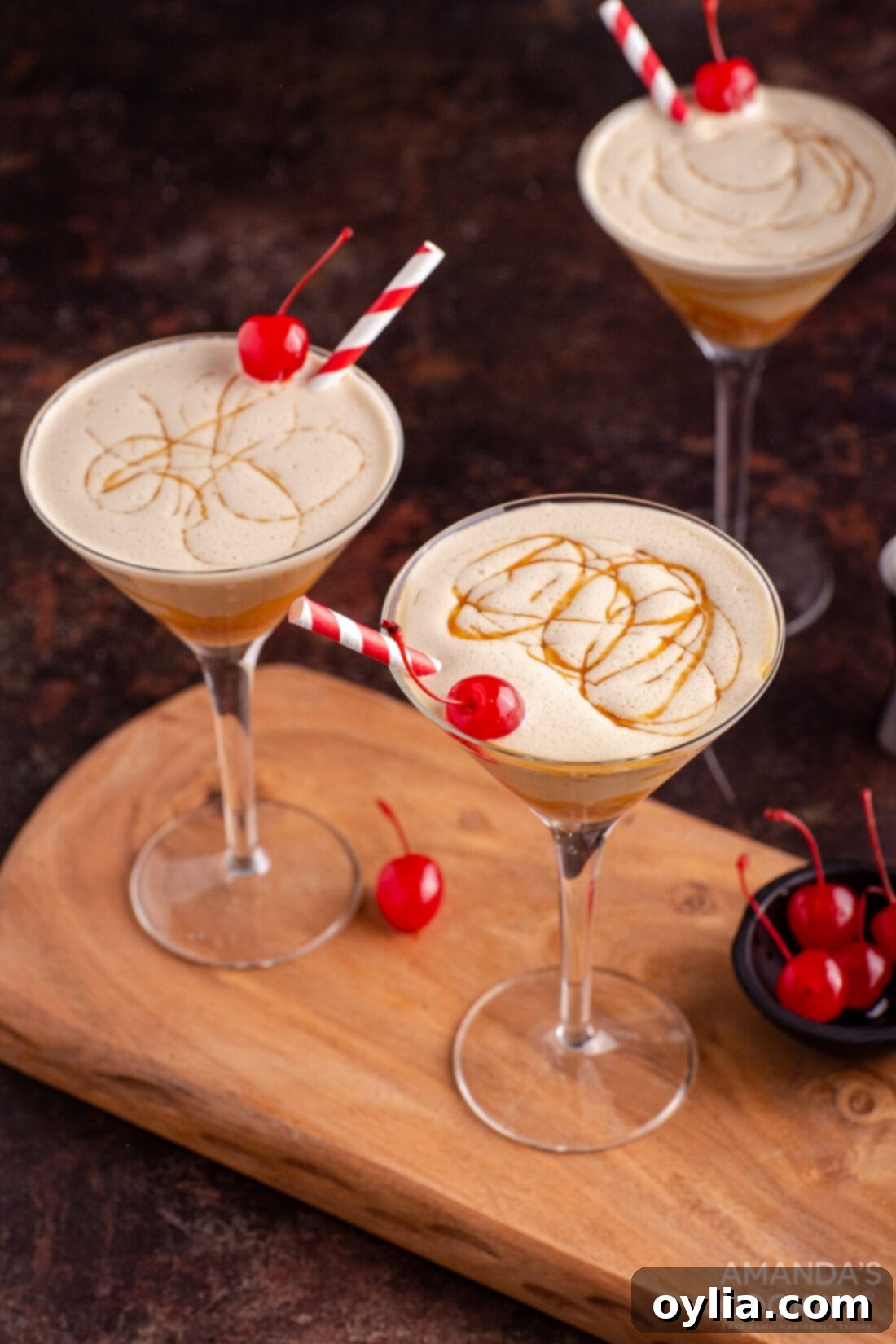 butterscotch milkshake cocktail in a martini glass with a cherry garnish