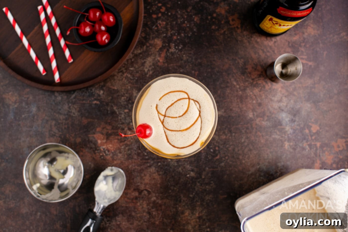 butterscotch milkshake cocktail in a martini glass with a cherry garnish