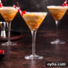 butterscotch milkshake cocktail in a martini glass with a cherry garnish