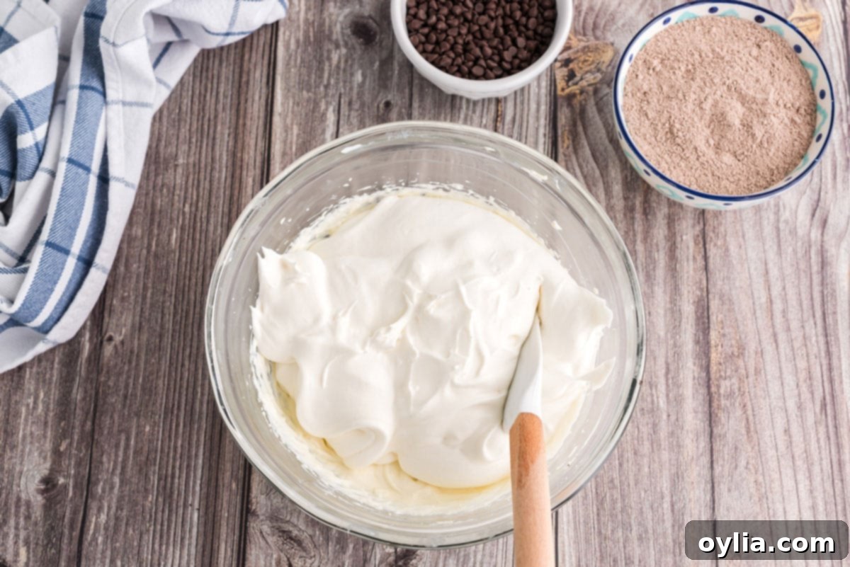 Decadent Chocolate Lasagna 9 folding cool whip into the cream cheese mixture with a rubber spatula