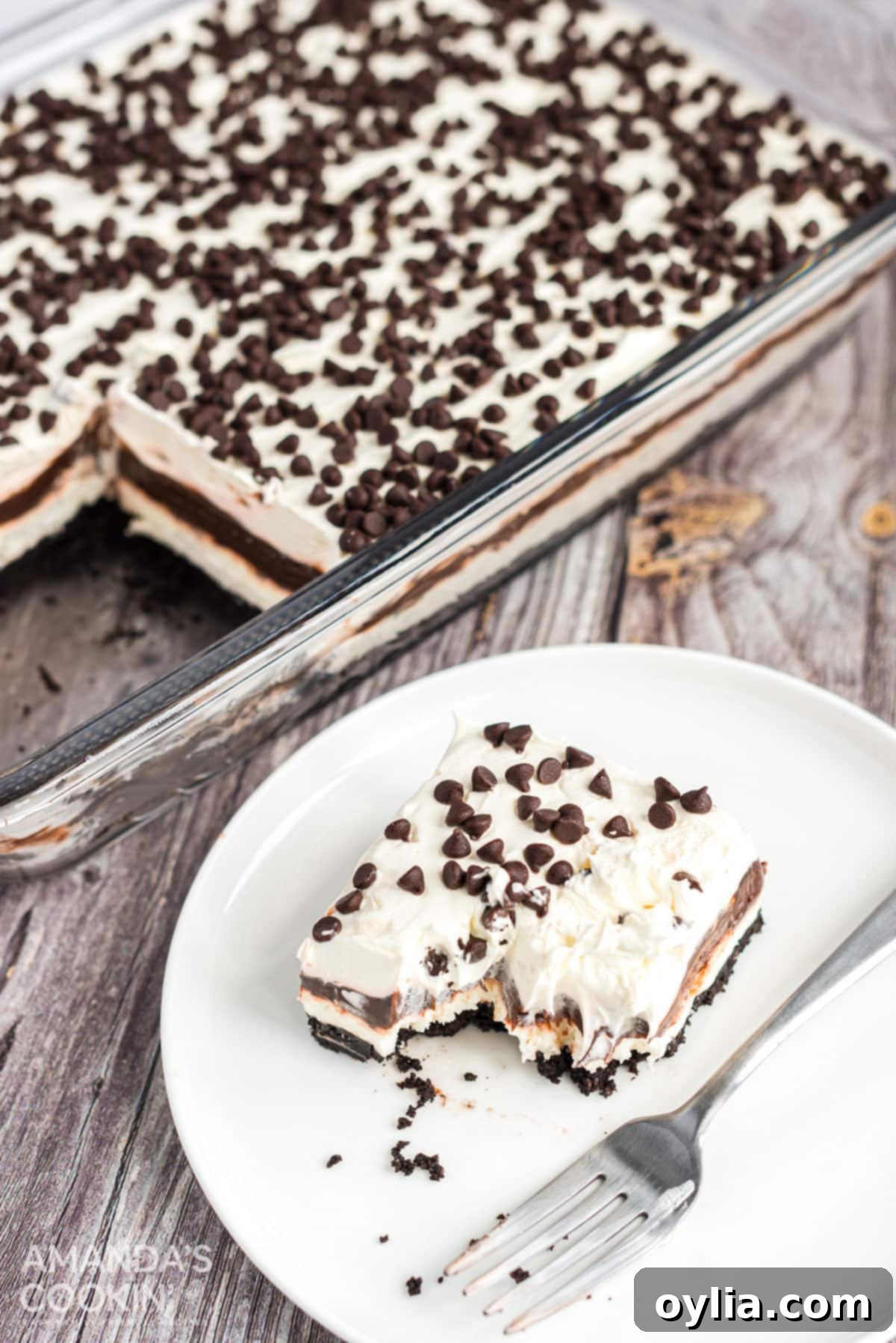 Chocolate lasagna is a no-bake layered dessert made with cookies, cream cheese, whipped cream and chocolate pudding. It's a chocolate dessert dream! slice of chocolate lasagna with a forkful removed, ready to be eaten