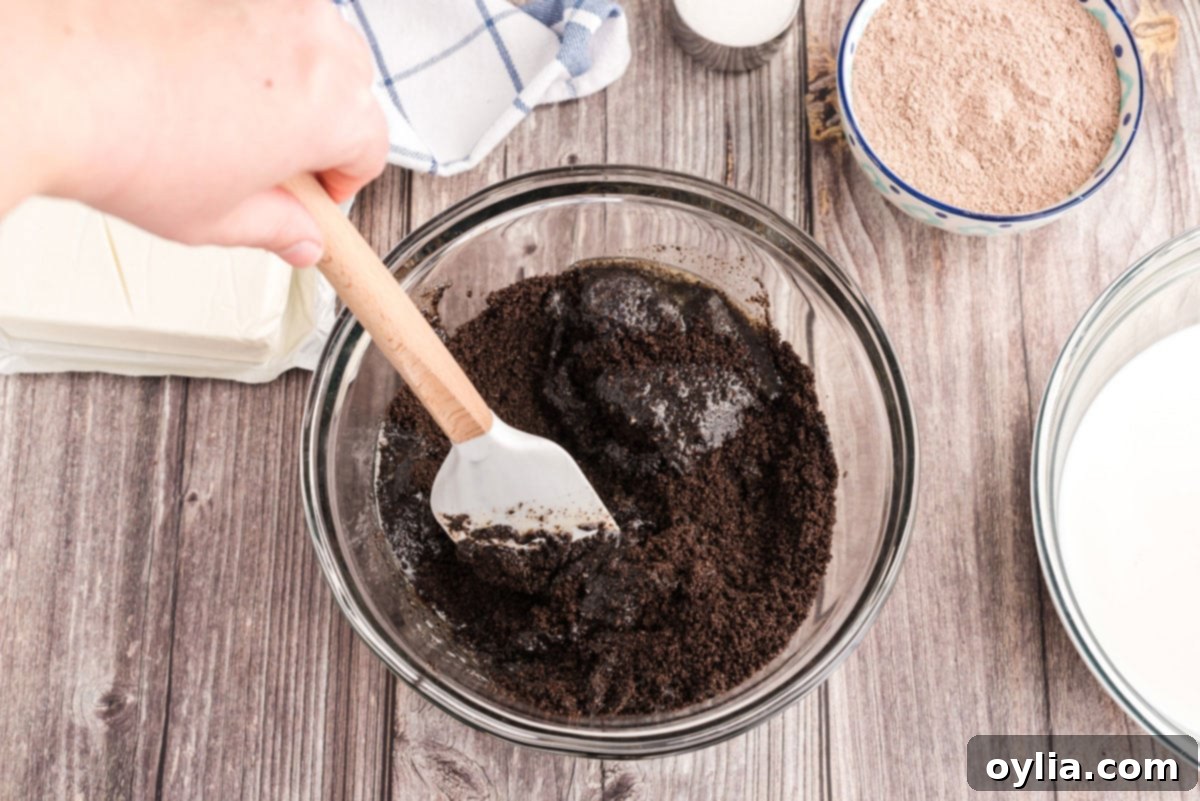 Decadent Chocolate Lasagna 5 stirring melted butter into oreo cookie crumbs in a bowl