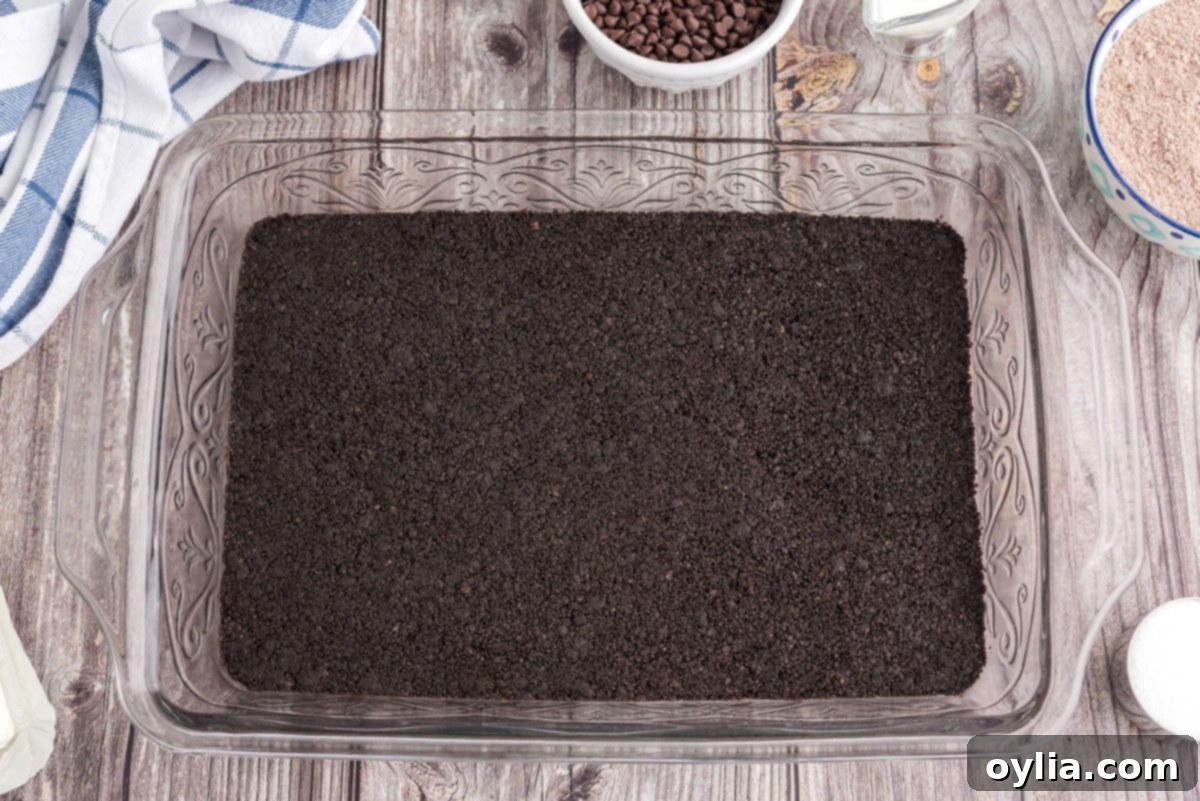 Decadent Chocolate Lasagna 6 evenly pressed oreo cookie crust in a 13x9 inch baking pan