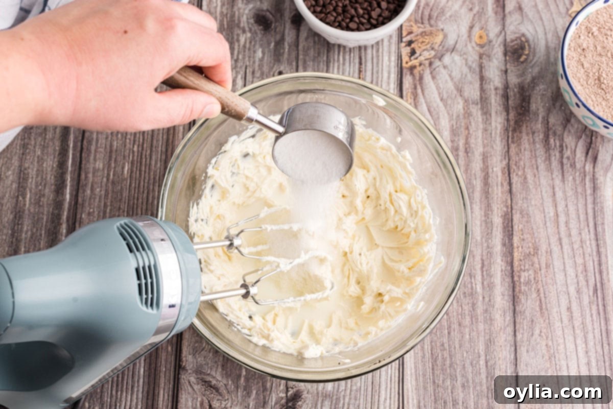 Decadent Chocolate Lasagna 8 adding granulated sugar to a bowl of beaten cream cheese and milk