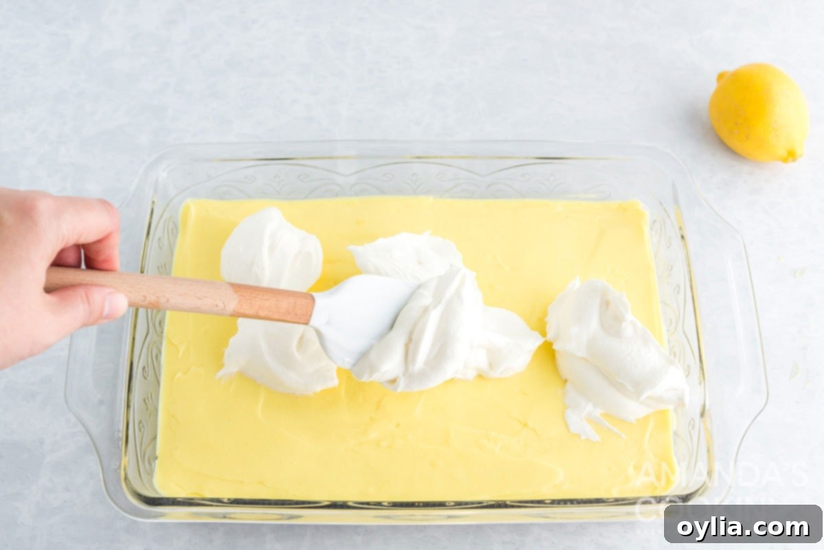 spreading whipped cream over pudding layer
