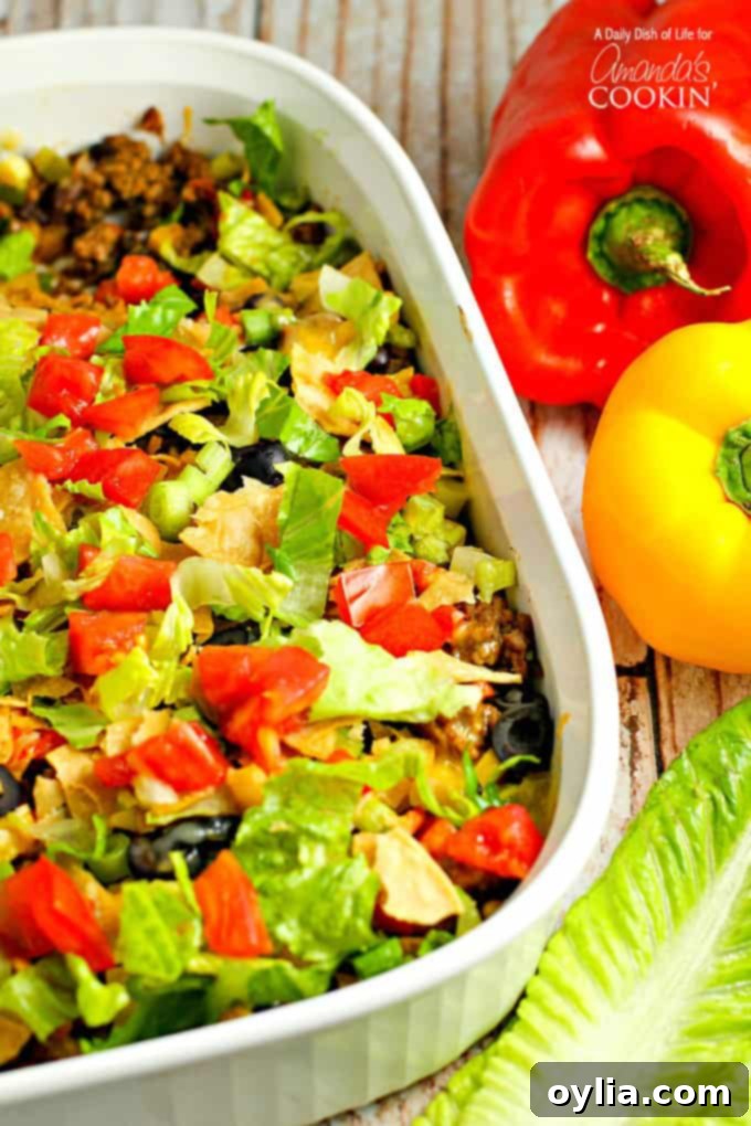 Cheesy Taco Casserole 2 Delicious Taco Casserole with melted cheese, seasoned beef, and fresh toppings