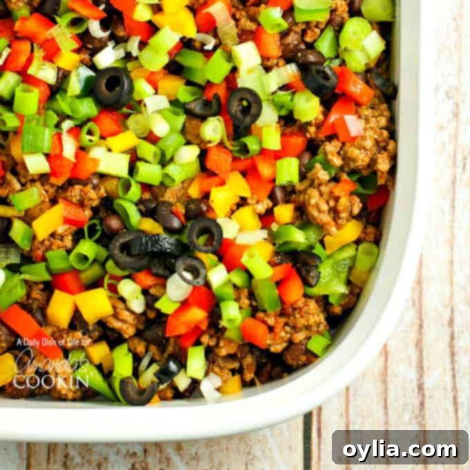 Cheesy Taco Casserole 9 Veggie-topped taco casserole, before adding cheese, ready to bake