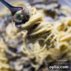 One-Pan Mushroom Stroganoff 5 A close up of creamy mushroom stroganoff swirled onto a fork, ready to eat.