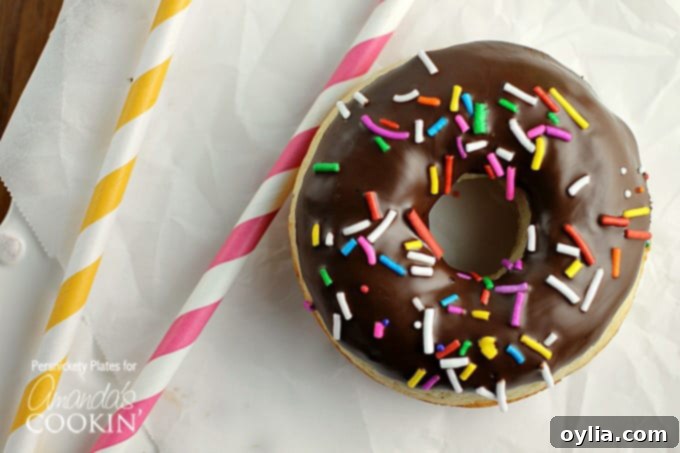 Homemade baked cake donuts with chocolate topping and colorful sprinkles