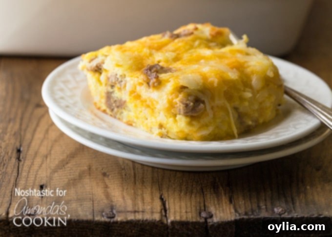A square serving of turkey hash brown breakfast casserole on a white plate.