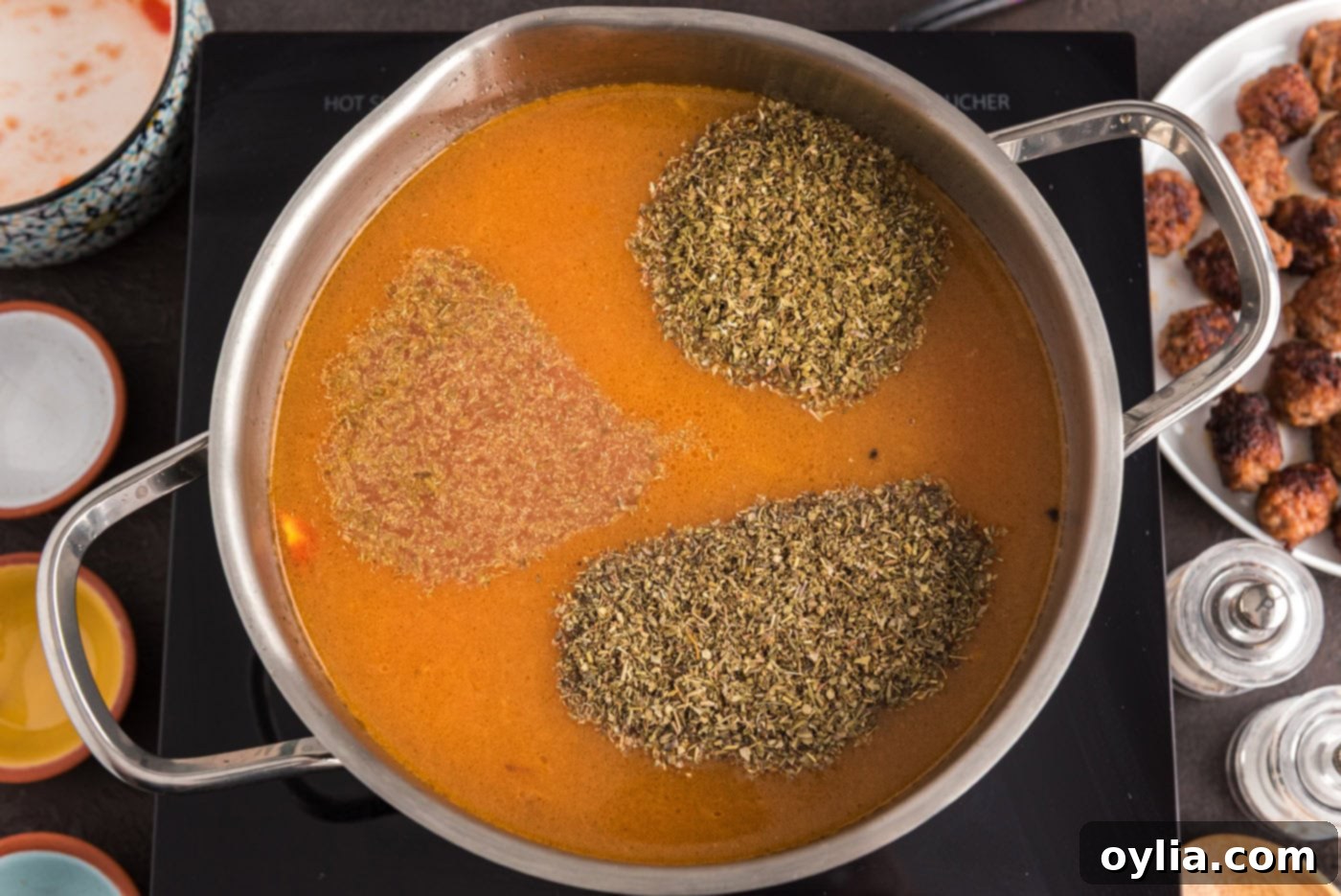 seasonings added to soup in pot