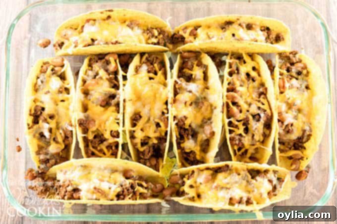 An overhead of beef and bean tacos in  clear dish.