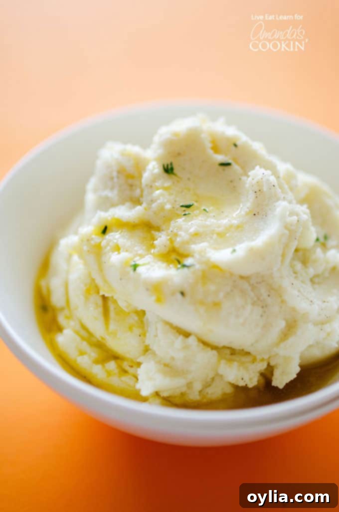 A close up of mashed cauliflower with melted butter on top.