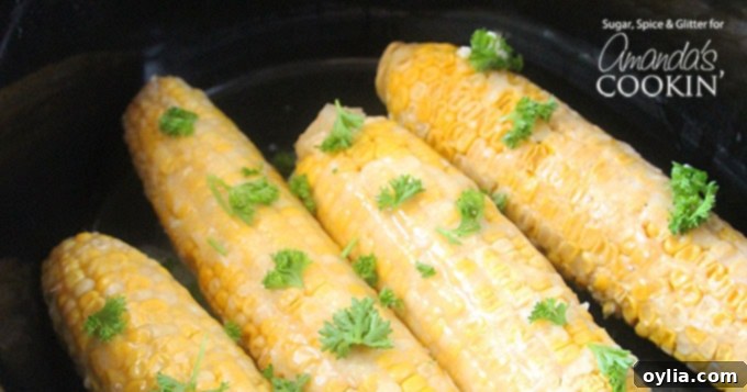 A close up of freshly cooked and buttered corn on the cob in a slow cooker, ready to be served.