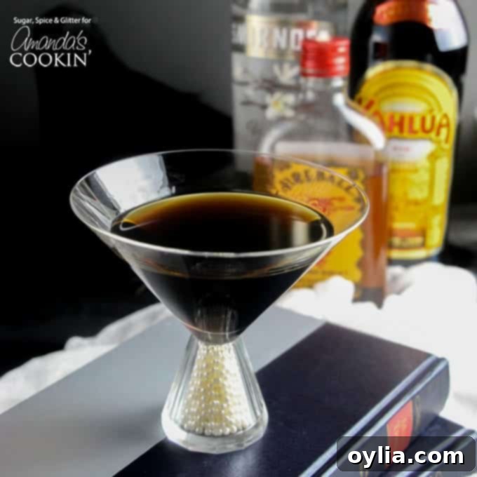 A photo of a raven coffee cocktail in a wide-mouthed glass, with a feather garnish.
