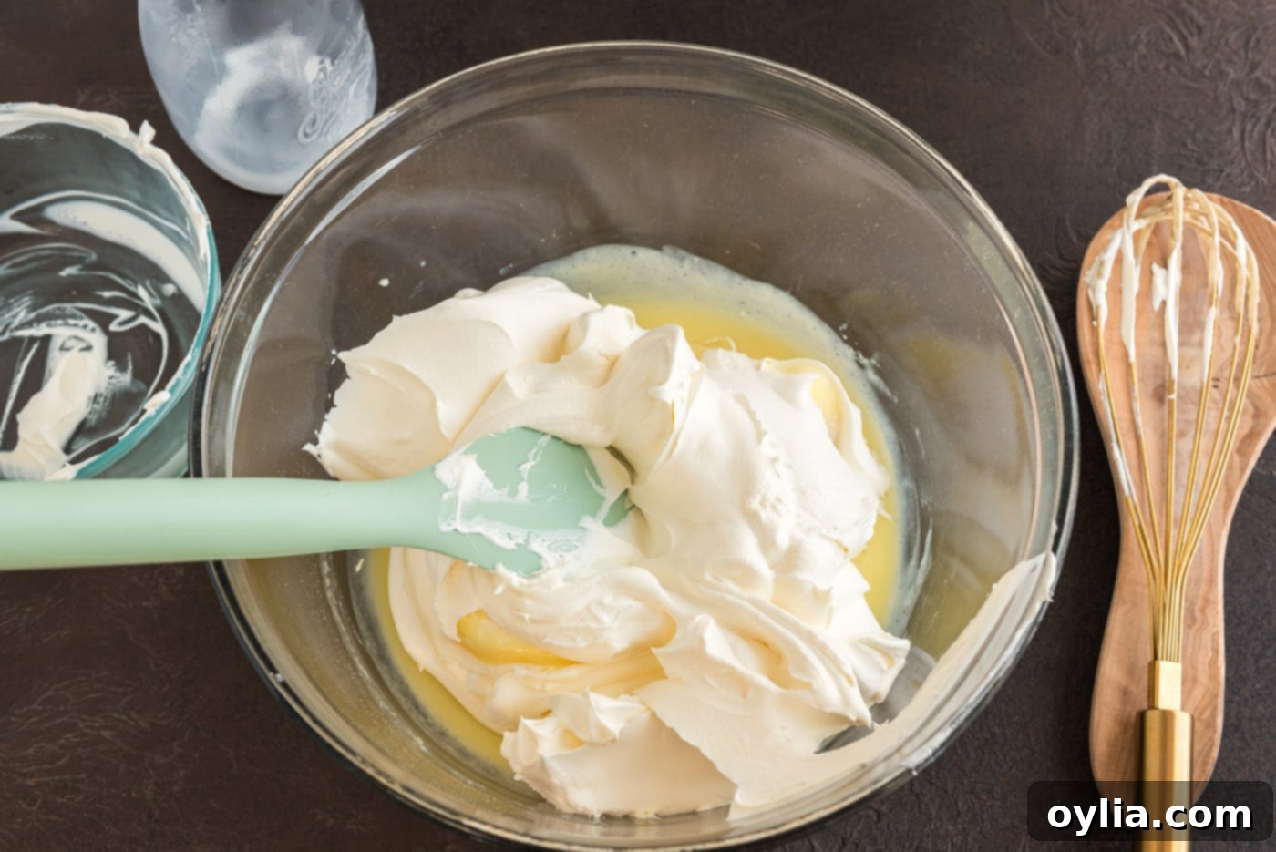 gently folding Cool Whip into the vanilla instant pudding mixture with a rubber spatula