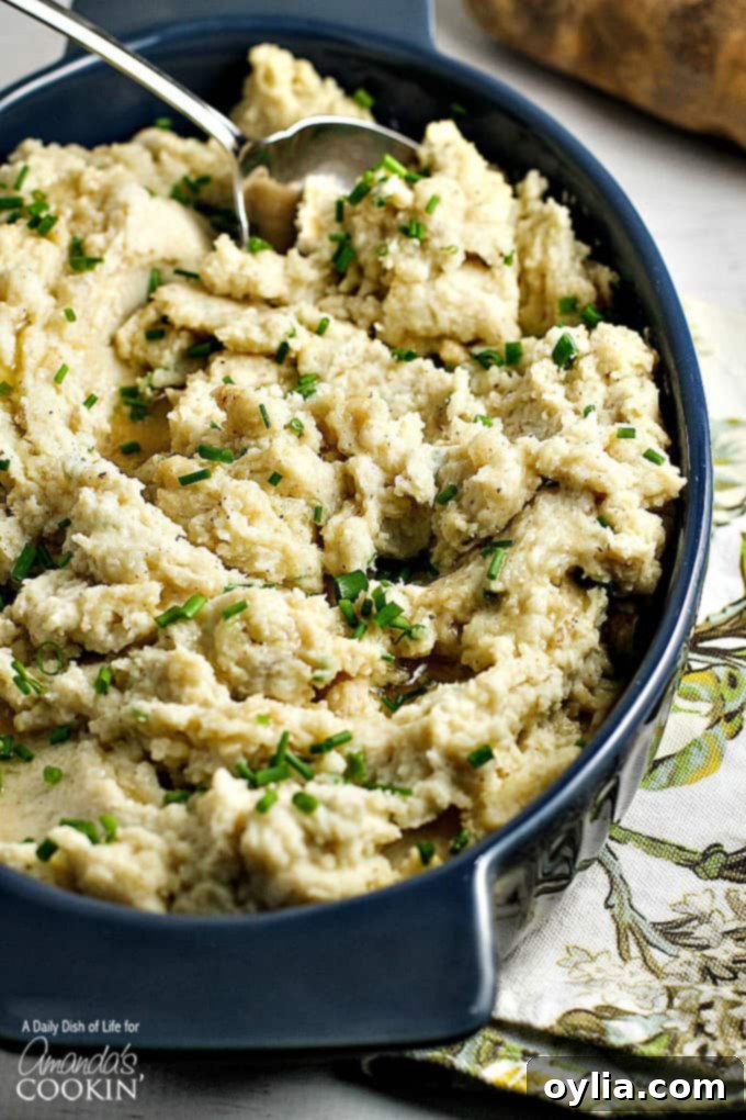 A close up overhead picture of brown butter mashed potatoes, garnished with fresh chives.