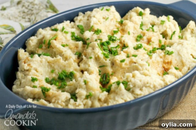 A bowl of brown butter mashed potatoes with chives on top, ready to be served.
