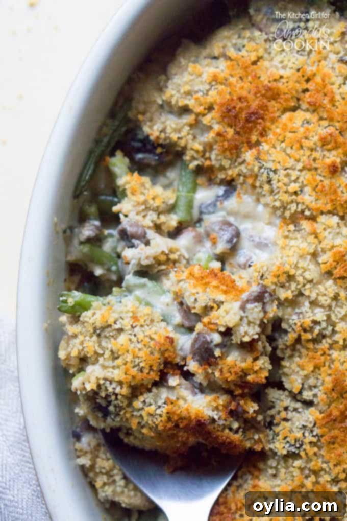 A close up overhead of green bean casserole, showing its creamy texture and crispy topping.