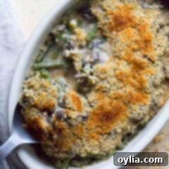 Our Family's Favorite Green Bean Casserole 5 An overhead of a homemade green bean casserole with a crispy topping.