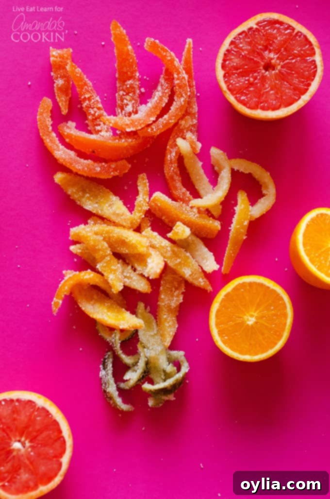 An overhead of candied grapefruit and orange peels, beautifully arranged and sparkling with sugar.
