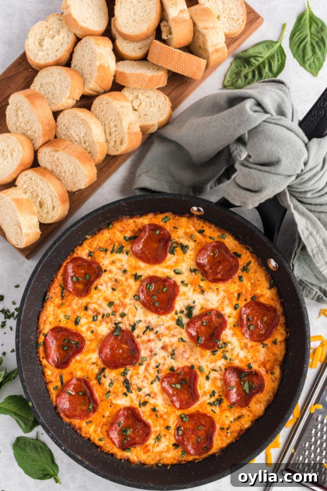 Ultimate Pizza Dip 3 pizza dip bubbling in a cast iron skillet, ready to serve
