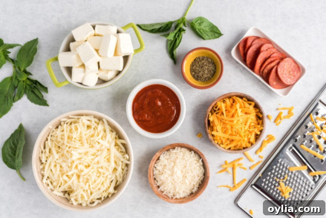 Ultimate Pizza Dip 4 various pizza dip ingredients laid out on a table