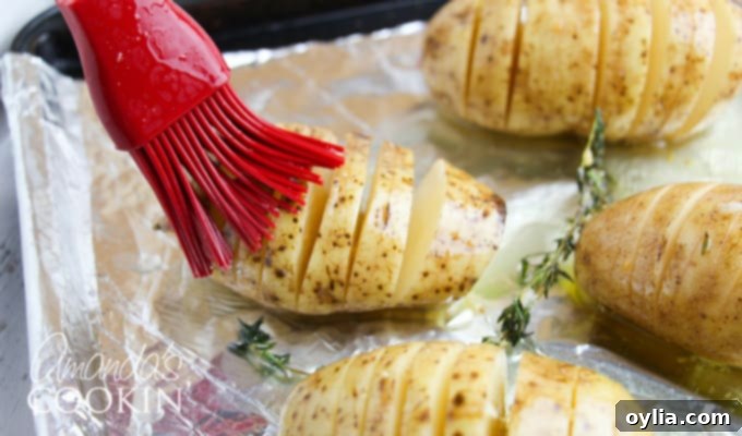 Hasselback potatoes step 2: sliced potatoes on a baking sheet.