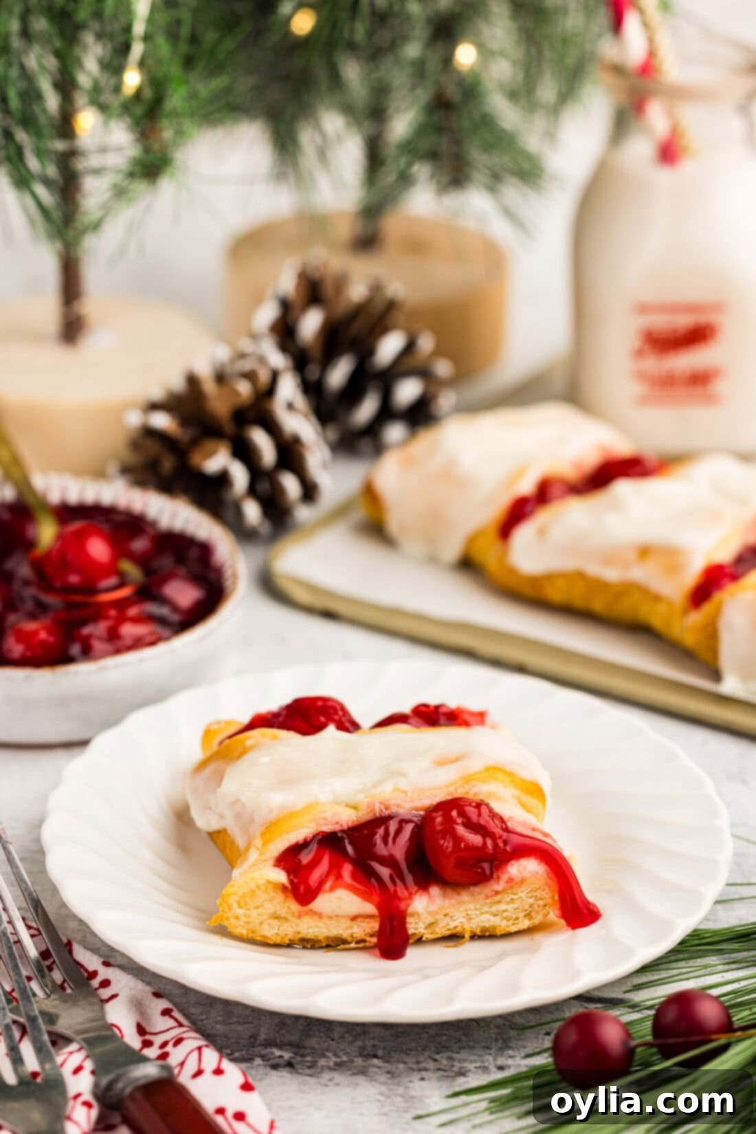 A delicious slice of Candy Cane Danish on a plate, showing the creamy filling and festive colors