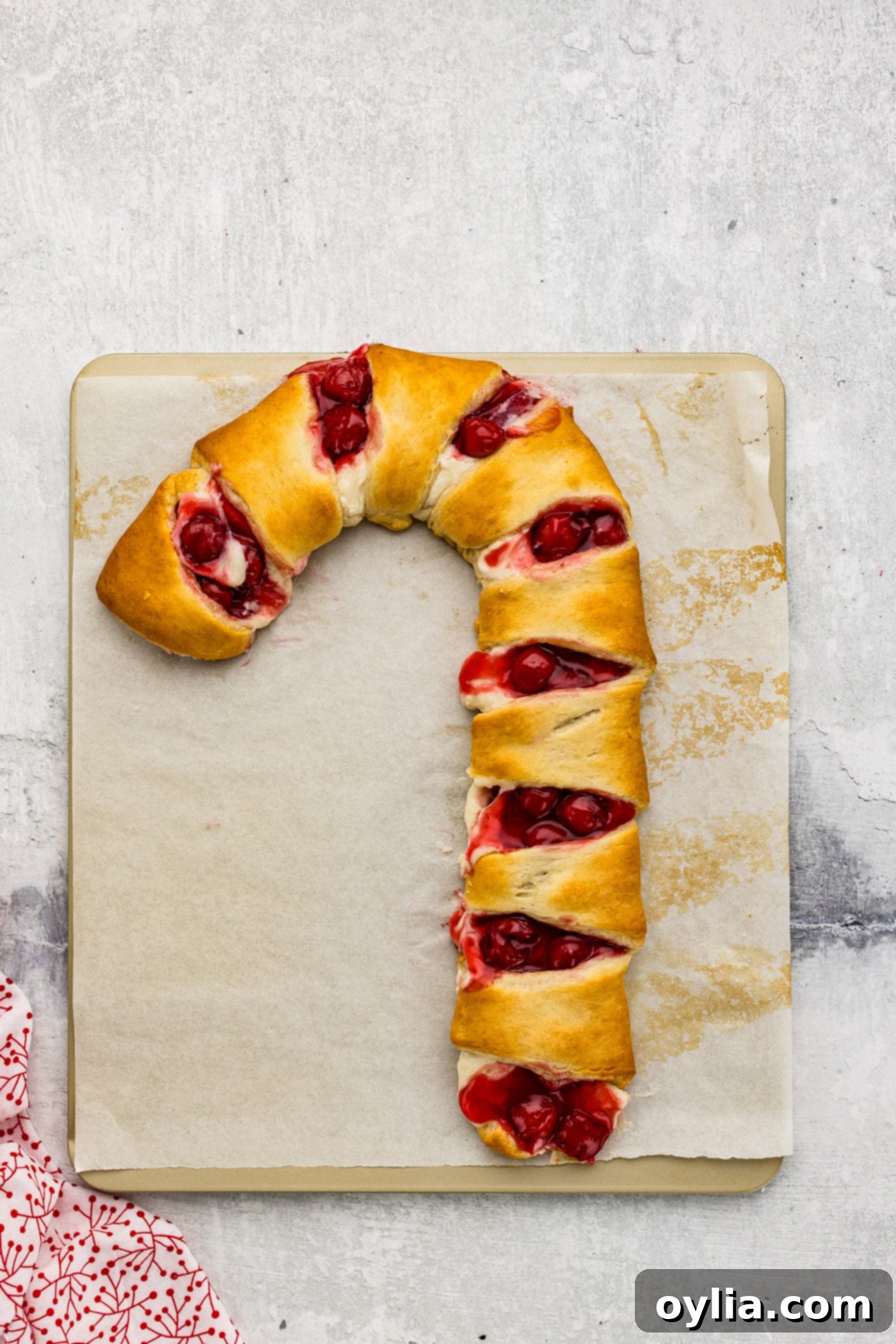 Baked candy cane danish made with crescent rolls, golden brown and ready for icing