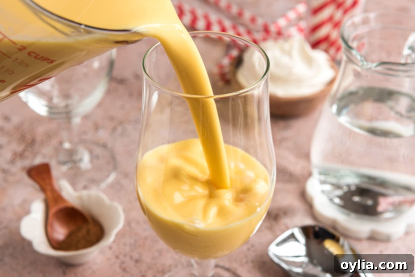 pouring eggnog into glass