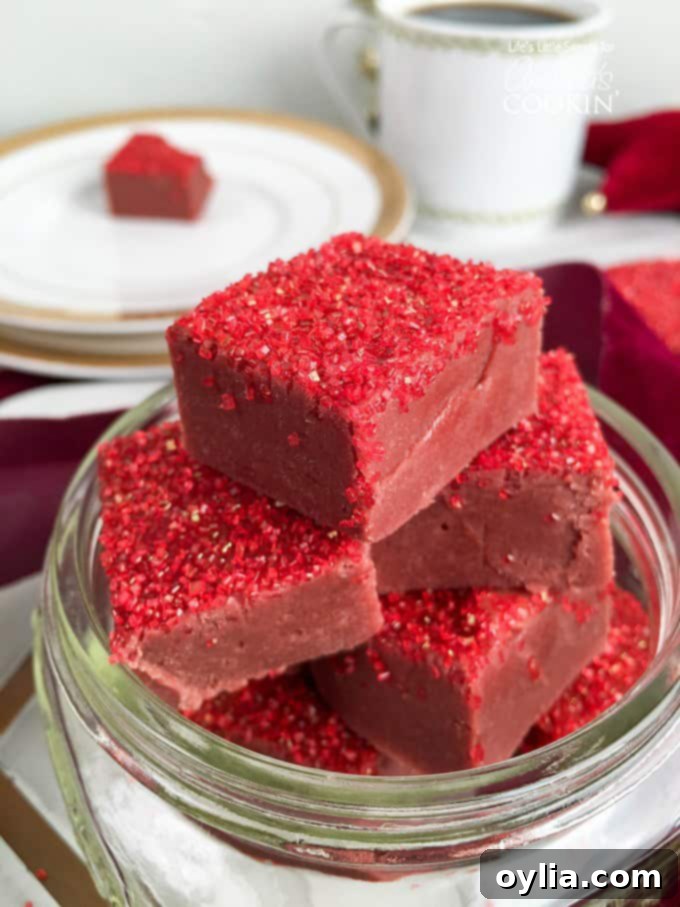 Squares of red velvet fudge with red sprinkles on top.