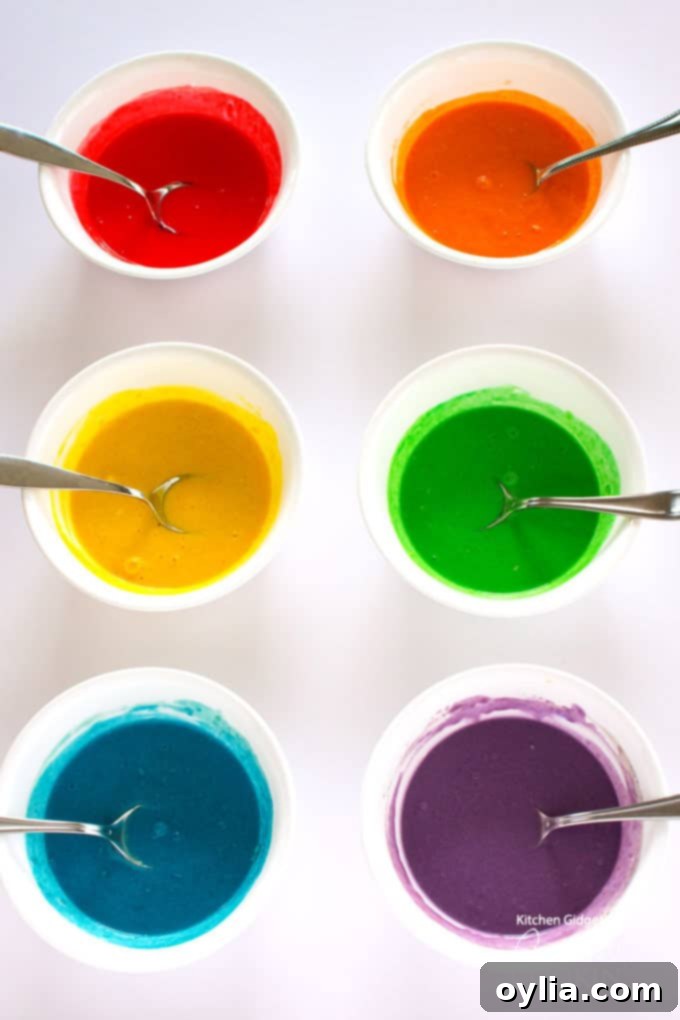 Colorful pancake mixes divided into six bowls, ready for cooking