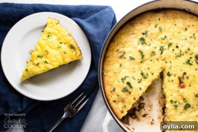 A slice of vegetable frittata on a white plate next to the pan of frittata.