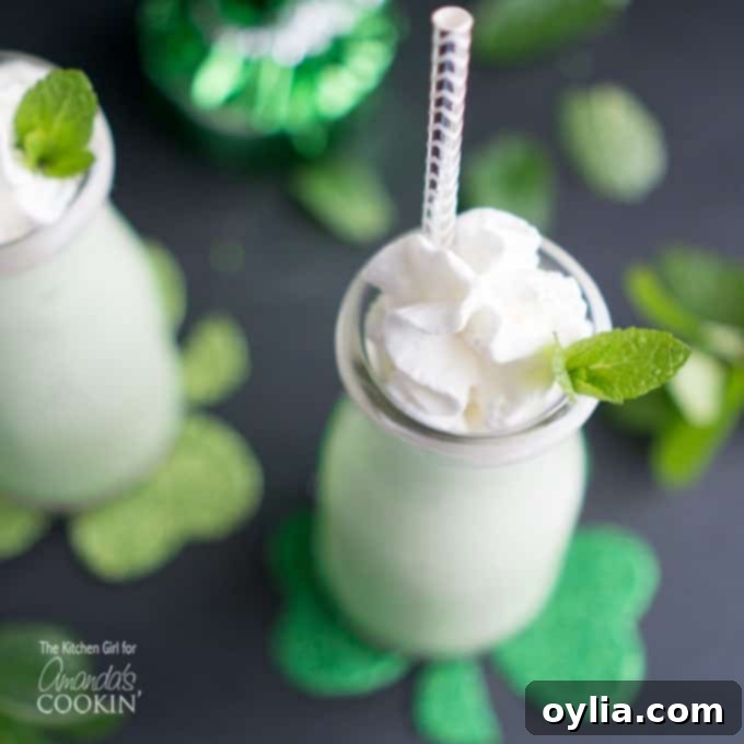 A close-up of a naturally green shamrock shake, made with fresh mint and no artificial colors, garnished with a mint leaf.