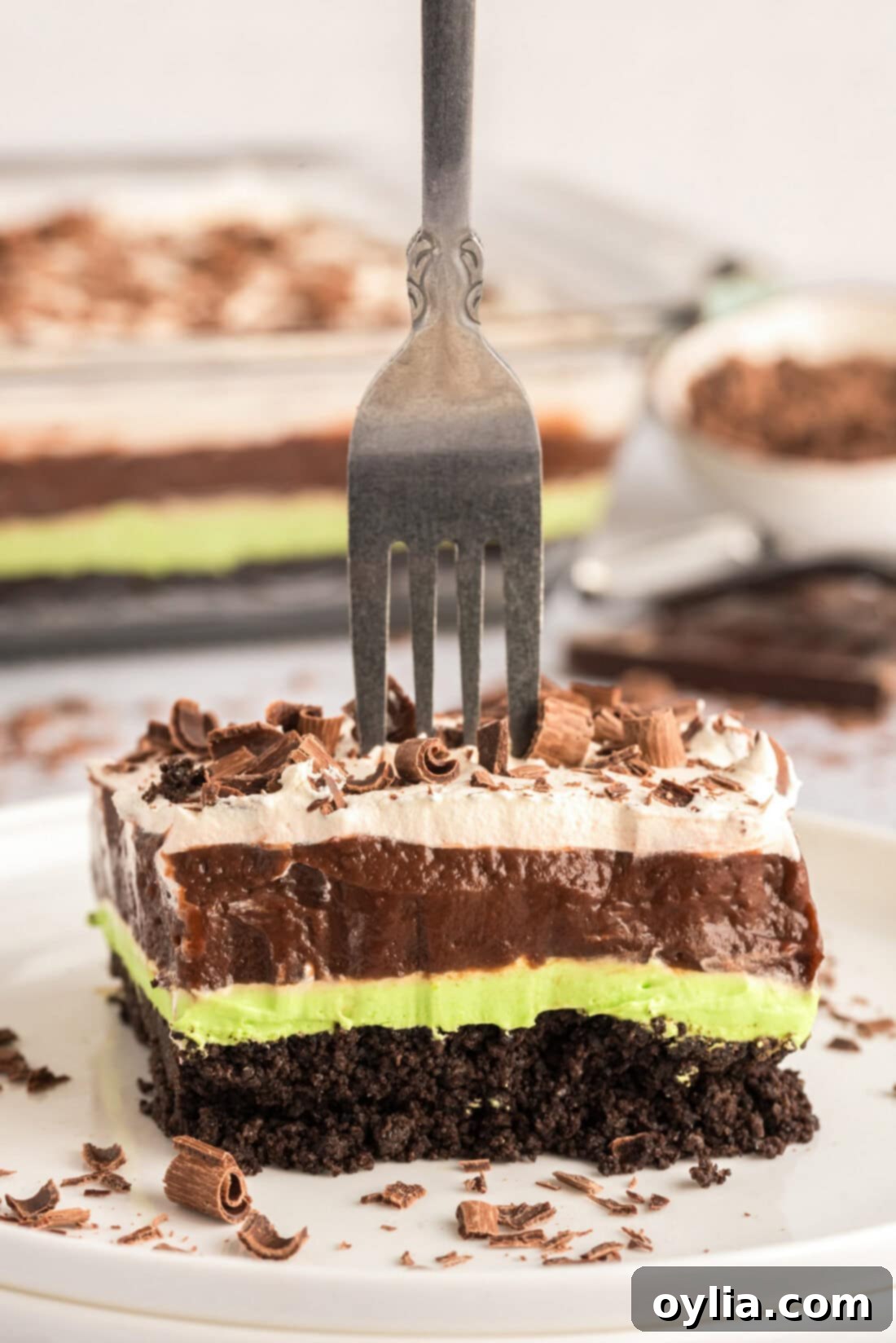 Fork stuck in a slice of Mint Chocolate Lasagna