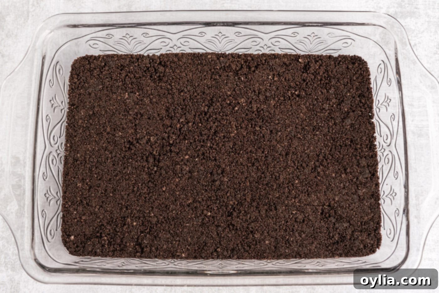 Oreo cookie crust in a baking pan