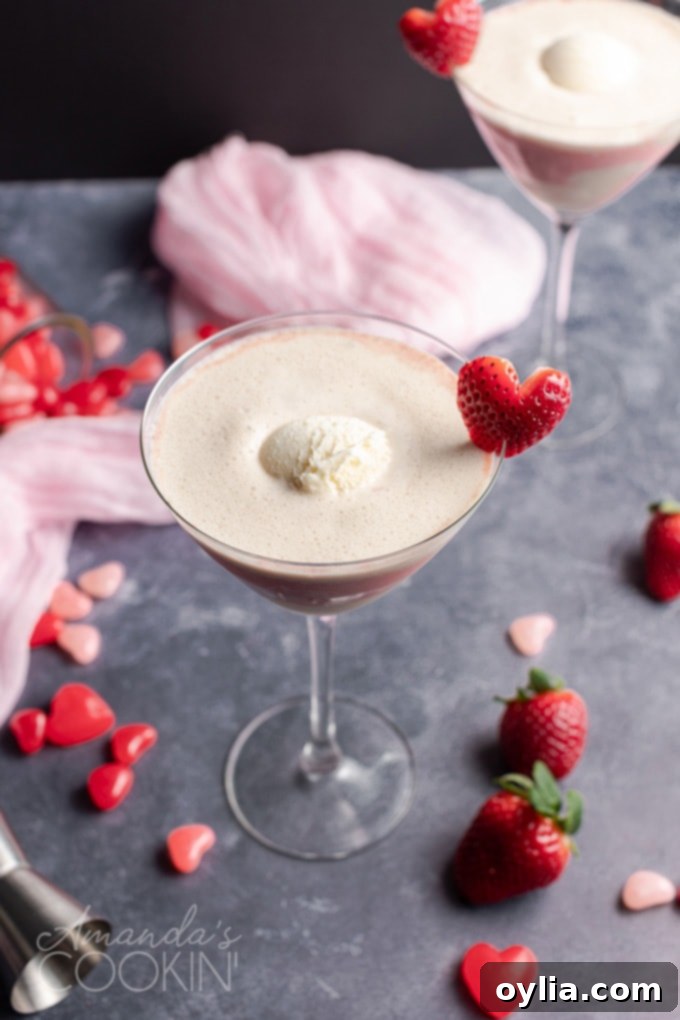 This Valentine's Mudslide adds fresh strawberries into the mix for a fresh and fruity take on a frozen cocktail classic. Make this for someone you love! #cocktails #valentinesday #mudslide #mudslidecocktail #partydrinks #strawberry #icecream #baileys #kahlua scoop of vanilla ice cream in mudslide drink