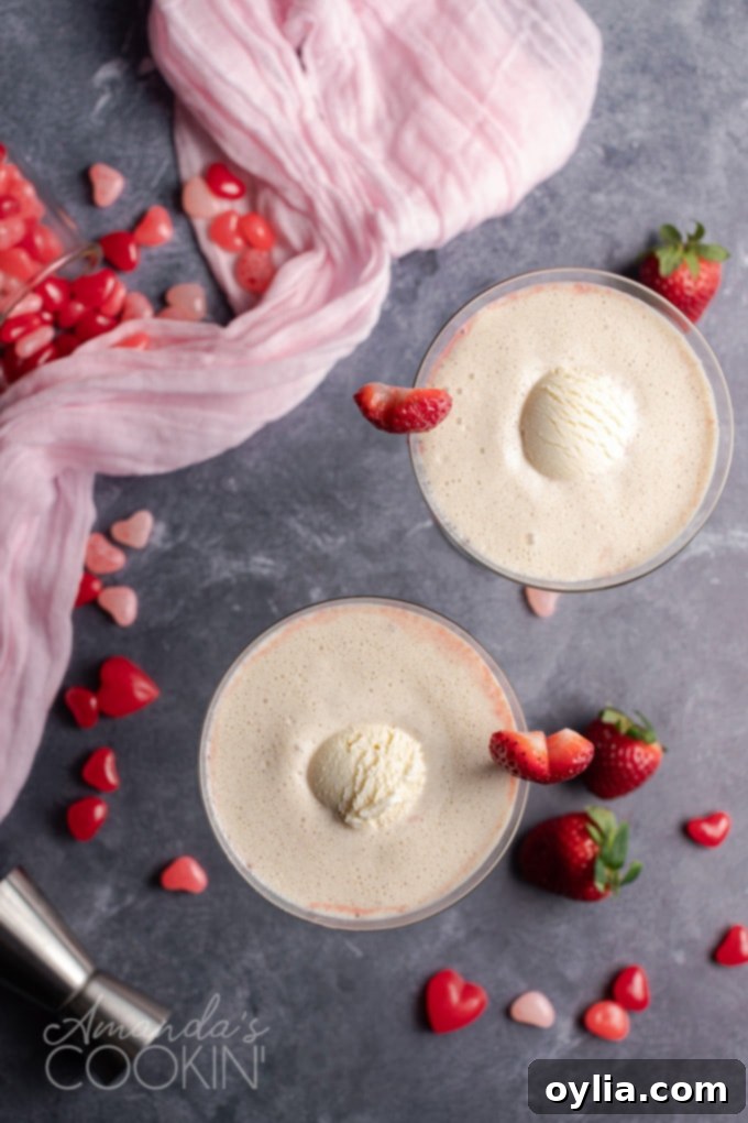 This Pink Mudslide uses fresh strawberries and vanilla ice cream along with Irish cream, coffee liqueur, and vodka for an amazing dessert Valentine's drink! overhead view of pink mudslide for valentines day