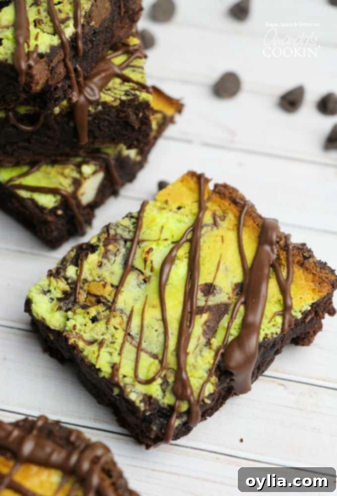 A close up of a marbled mint cheesecake brownie, showcasing its vibrant green swirl and fudgy texture.