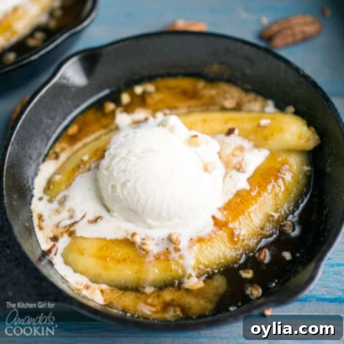 A delightful close-up of a single serve banana foster dessert, showcasing the warm, rum-infused caramel sauce gently flowing over a scoop of vanilla ice cream, all nestled in a miniature cast iron skillet. Chopped pecans are sprinkled on top.