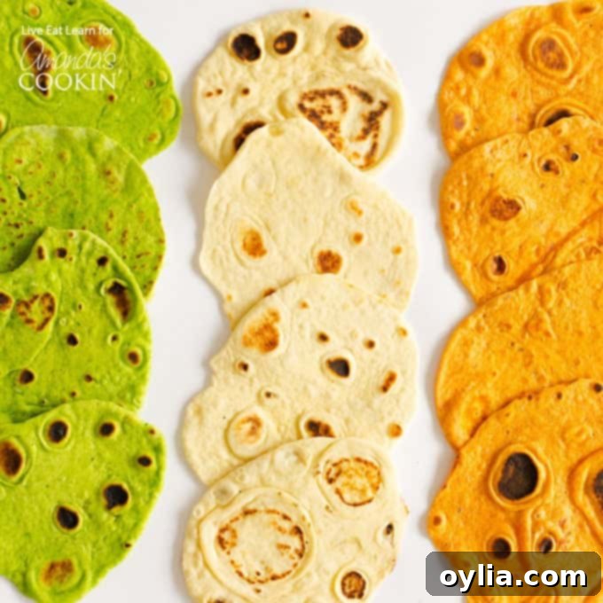 An overhead picture of three different kinds of homemade tortillas laying on a white platter.