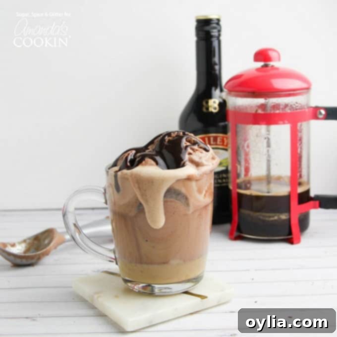 Baileys Coffee Float in a clear glass mug, garnished with chocolate syrup