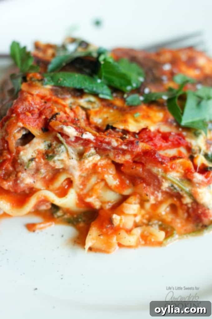Garden Veggie Lasagna 6 A close up of veggie lasagna on a white plate.