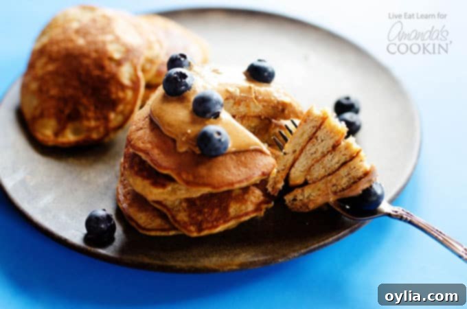 stack of flourless banana pancakes with a fork ready to eat