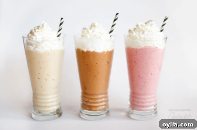 Three vibrant nice cream milkshakes with whipped cream and decorative straws, showcasing strawberry, vanilla, and chocolate flavors.