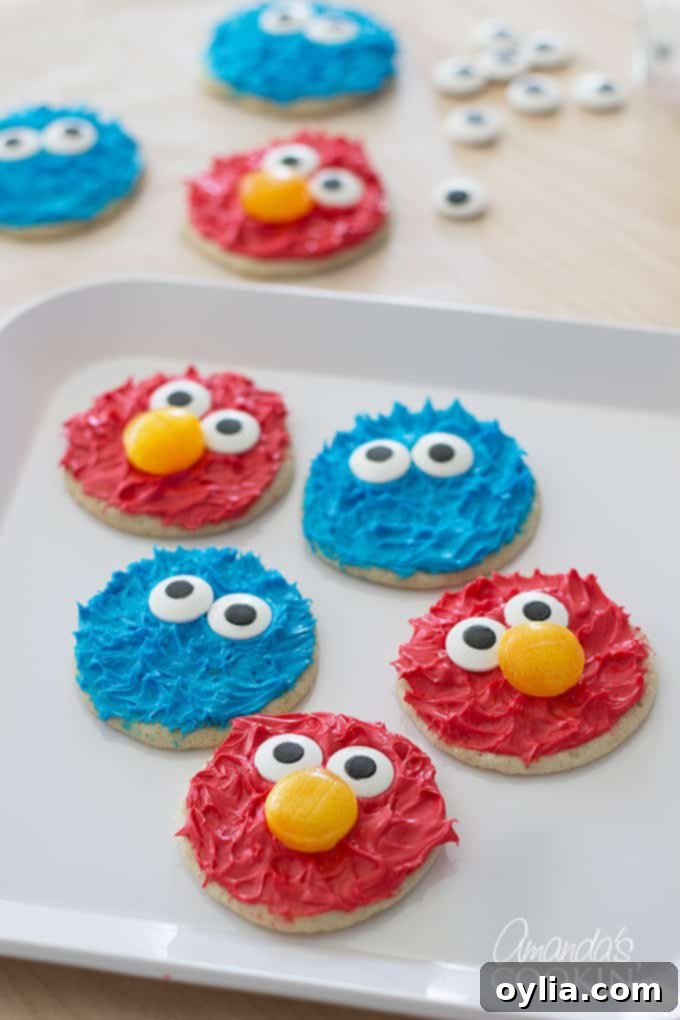 Delicious Cookie Monster and Elmo cookies on a white plate, ready for a party.