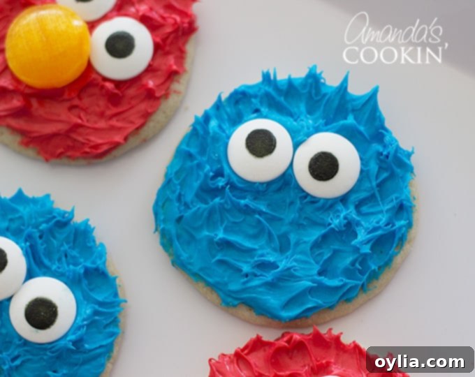 A plate featuring both Cookie Monster and Elmo cookies, perfect for a Sesame Street gathering.
