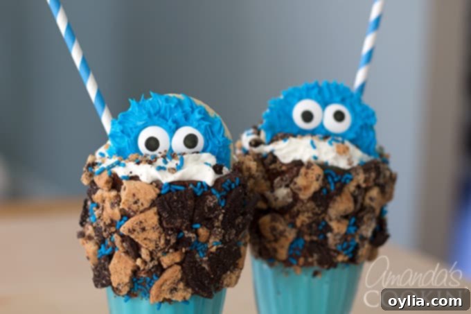 A close-up of a Cookie Monster Freak Shake, highlighting the blue milkshake, whipped cream, sprinkles, and cookie decorations, emphasizing its cuteness and ease of making.